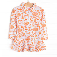 This tennis dress features an orange football themed print, a ruffle layered bottom, and the best performance fabric
