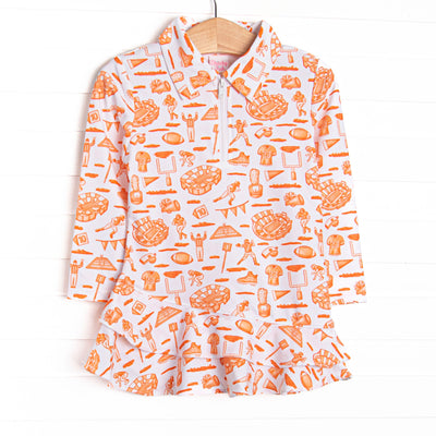 This tennis dress features an orange football themed print, a ruffle layered bottom, and the best performance fabric