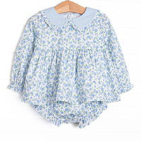 This set features a blue floral print, a peter pan collar with ruffle trim. and coordinating blue floral diaper cover.v