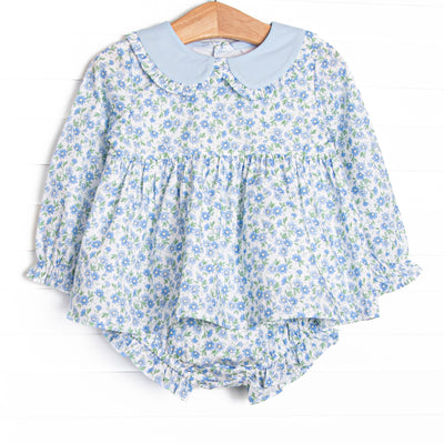 This set features a blue floral print, a peter pan collar with ruffle trim. and coordinating blue floral diaper cover.v