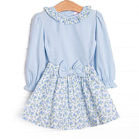  This&nbsp;set&nbsp;features a blue floral print, a ruffle collar, and a coordinating floral skirt to match. 