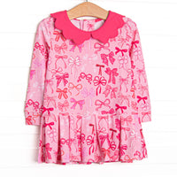  This dress features pink bow print, a scalloped hot pink collar, and the best performance fabric. 