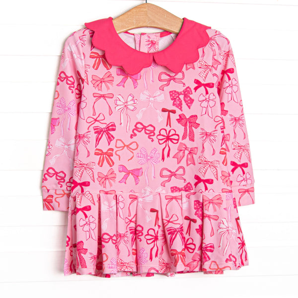  This dress features pink bow print, a scalloped hot pink collar, and the best performance fabric. 