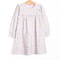  This dress features a pink pumpkin and bow print, ruffle neck trim, and long sleeves. 