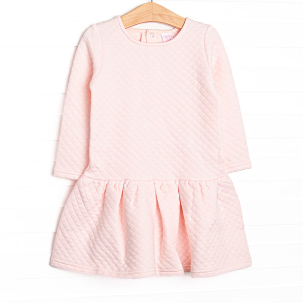 This dress features a cozy quilted pink material, snap closure on the back of neck, and ruffle hem.