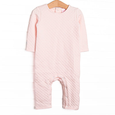  This romper features a cozy quilted pink material, long sleeves, and snaps at the stride and legs. 
