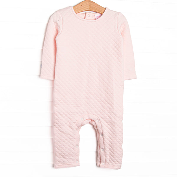  This romper features a cozy quilted pink material, long sleeves, and snaps at the stride and legs. 