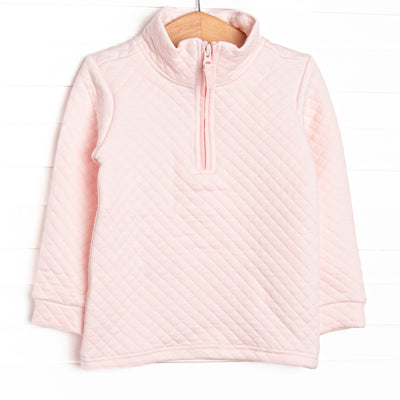  This pullover features a cozy quilted pink material, long sleeves, and a pink quarter zipper. 