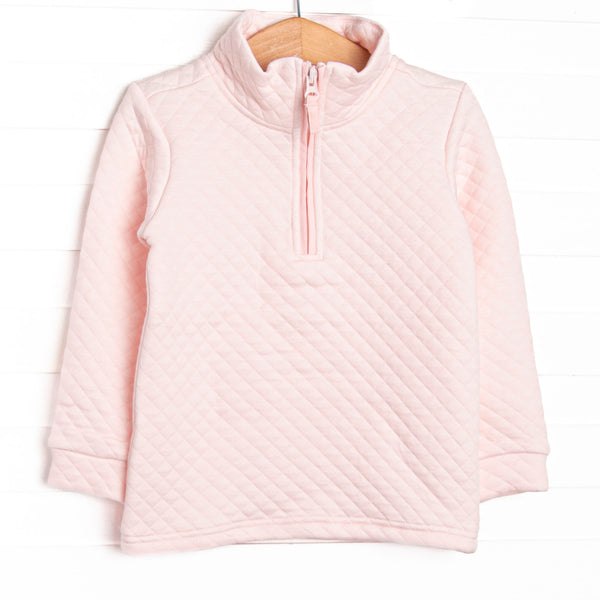  This pullover features a cozy quilted pink material, long sleeves, and a pink quarter zipper. 