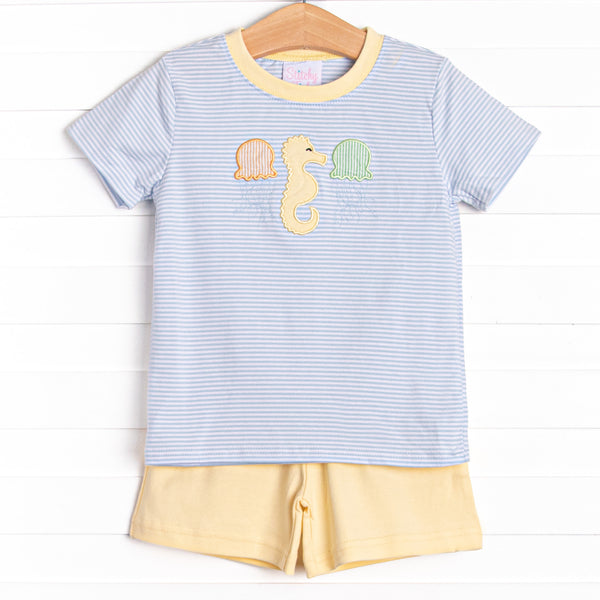  This set features a top in a blue striped print, a seahorse applique, and yellow shorts to match. 
