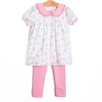 This set features a blue floral print, a pink eyelet lace trimmed collar, and short puff sleeves. Coordinating pink leggings to match.