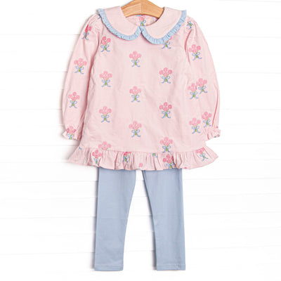 This set features pink corduroy fabric with rose embroidery, a ruffle trimmed Peter Pan collar, and ruffle trim. Coordinating blue leggings to match.
