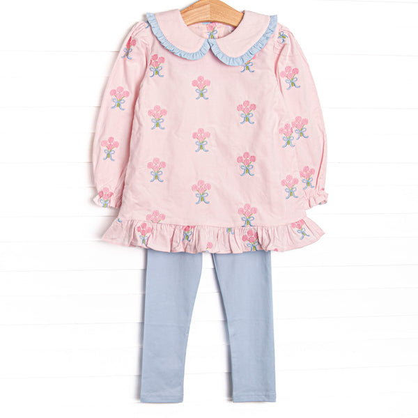 This set features pink corduroy fabric with rose embroidery, a ruffle trimmed Peter Pan collar, and ruffle trim. Coordinating blue leggings to match.