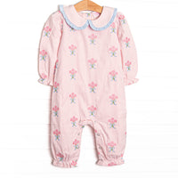  This romper features pink corduroy fabric with rose embroidery, a ruffle trimmed Peter Pan collar, and ruffle trim. 
