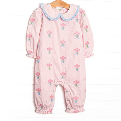  This romper features pink corduroy fabric with rose embroidery, a ruffle trimmed Peter Pan collar, and ruffle trim. 
