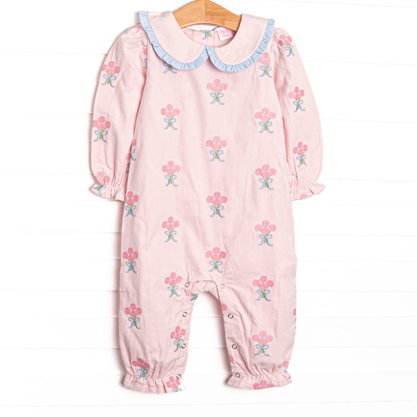 This romper features pink corduroy fabric with rose embroidery, a ruffle trimmed Peter Pan collar, and ruffle trim. 