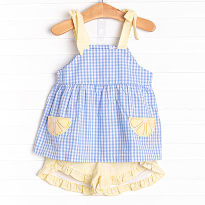  This set features a blue gingham print, yellow seersucker straps, and lemon slice appliques. Coordinating yellow seersucker shorts to match. 
