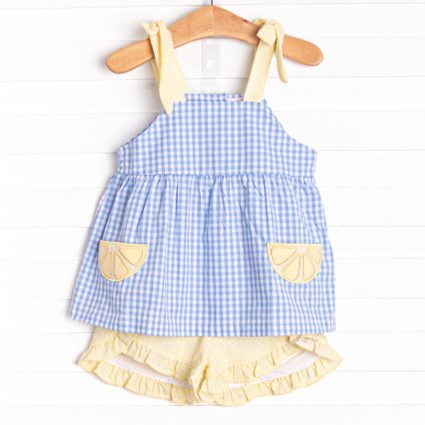  This set features a blue gingham print, yellow seersucker straps, and lemon slice appliques. Coordinating yellow seersucker shorts to match. 