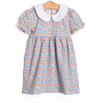 This dress features a blue floral print, puff sleeves, and a peter pan collar.