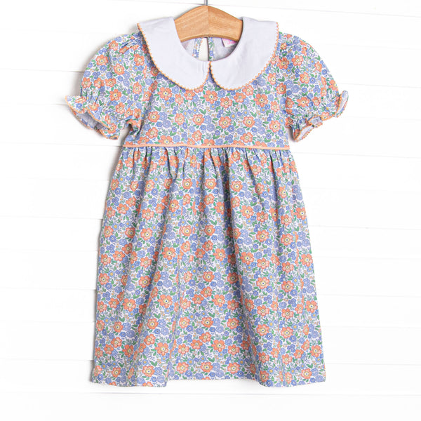 This dress features a blue floral print, puff sleeves, and a peter pan collar.