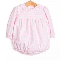 This bubble features pink windowpane fabric, a ruffle collar, and long sleeves.