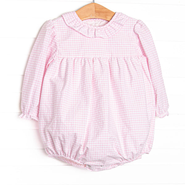 This bubble features pink windowpane fabric, a ruffle collar, and long sleeves.