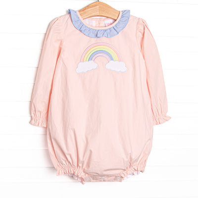  This bubble features pink woven fabric, a rainbow applique, and a blue gingham ruffle neck. 