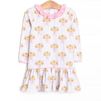 This dress features a sunflower print, a pink ruffle neck, and long sleeves.