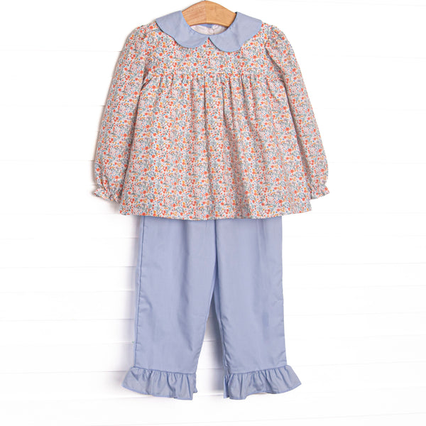 This set features a floral print, a blue scalloped collar, and long sleeves. Coordinating blue ruffle pants to match.