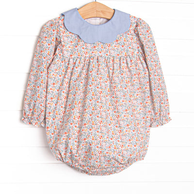 This bubble features a floral print, a blue scalloped collar, and long sleeves.