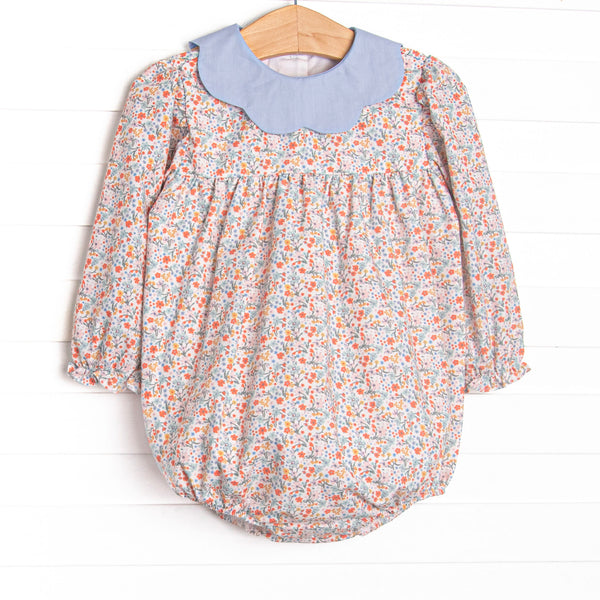 This bubble features a floral print, a blue scalloped collar, and long sleeves.