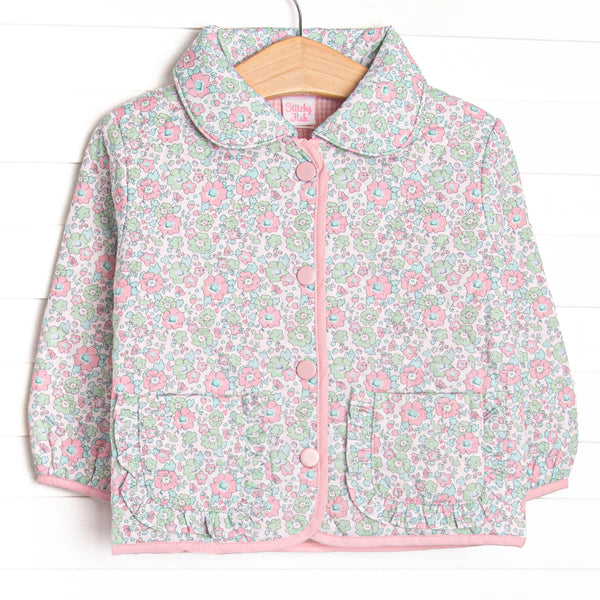  This coat features a green floral quilted material, a peter pan collar, and pink buttons. 