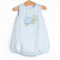  This bubble features a mint green seersucker print, front covered buttons, and a turtle applique. 