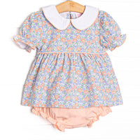 This set features a blue floral print, puff sleeves, and a peter pan collar. coordinating peach pink diaper cover to match.