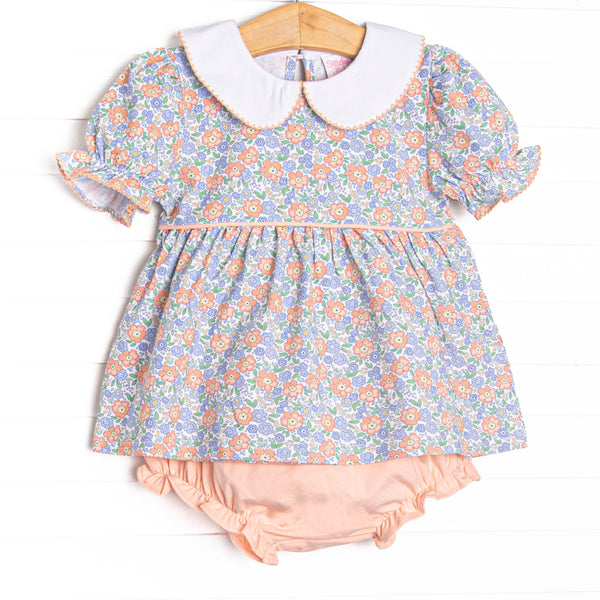 This set features a blue floral print, puff sleeves, and a peter pan collar. coordinating peach pink diaper cover to match.