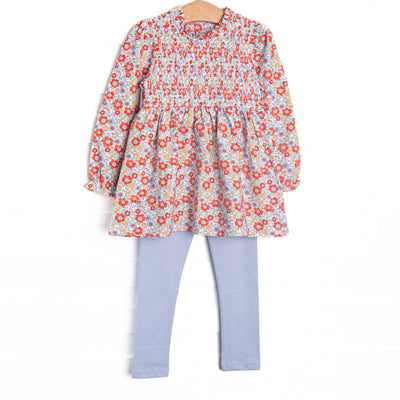 This set features a red floral print, chest smocking, and long sleeves. Coordinating blue leggings to match.