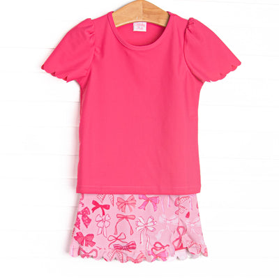  This set features a pink bow printed skort, a hot pink flutter sleeve top, and scallop edge embroidery. 