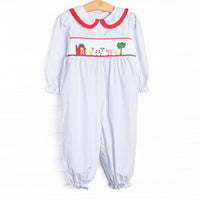  This romper features a blue windowpane print, red ruffle trim, and a barn smocking. T