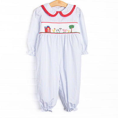  This romper features a blue windowpane print, red ruffle trim, and a barn smocking. T
