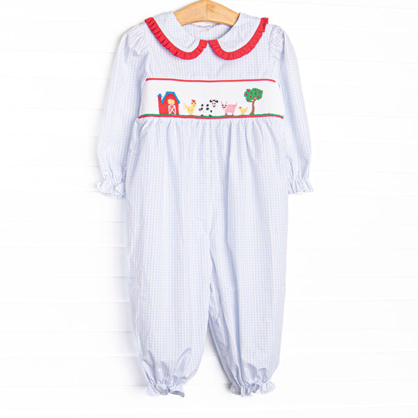  This romper features a blue windowpane print, red ruffle trim, and a barn smocking. T