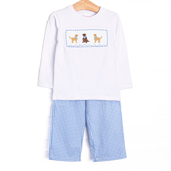 This set features a white top, golden retriever trio smocking, and long sleeves. Coordinating blue gingham pants to match.