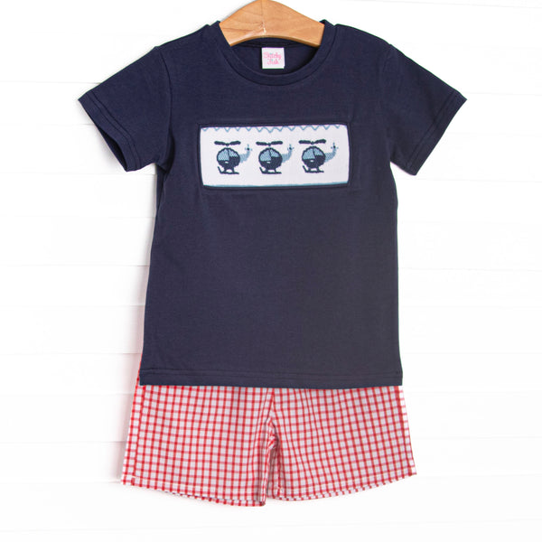 This set features navy fabric, helicopter smocking, and short sleeves. Coordinating red windowpane shorts to match.