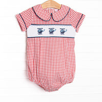  This bubble features red windowpane fabric, helicopter smocking, and a navy blue trimmed Peter Pan collar. 