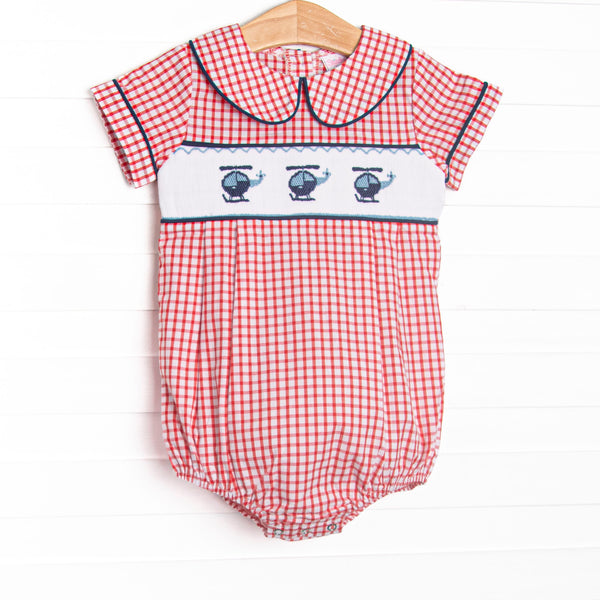  This bubble features red windowpane fabric, helicopter smocking, and a navy blue trimmed Peter Pan collar. 