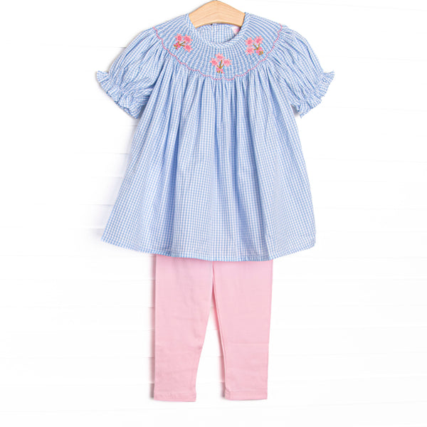 This set features blue gingham fabric, floral smocking, and short puff sleeves. Coordinating pink leggings to match.