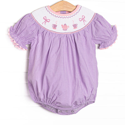 This bubble features a purple gingham print, puff sleeves, and a tea party.
