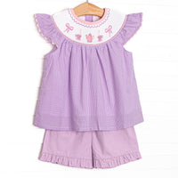 This set features a purple gingham print, flutter sleeves, and a tea party. Coordinating purple ruffle shorts to match.