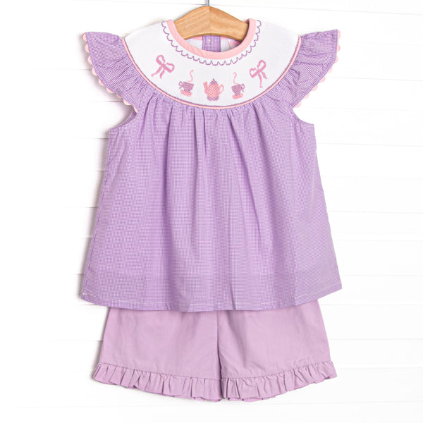 This set features a purple gingham print, flutter sleeves, and a tea party. Coordinating purple ruffle shorts to match.