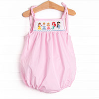 This bubble features a pink mini gingham print, shoulder ties. and princess smockings.