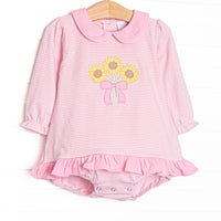 This skirted bubble features pink striped knit fabric, sunflower applique, a pink Peter Pan collar, and long sleeves.